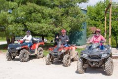 A group of ATV riders giving the thumb's up for the ride!