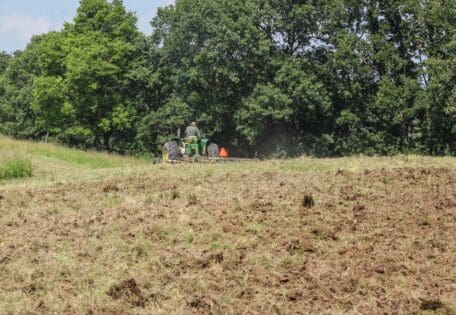 Tractor discing up a fall food plot for brassica seeding.