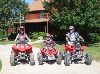 Family riding atv's at the lodge