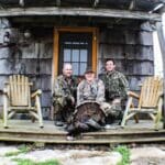 Guide and hunters posing with their turkey.