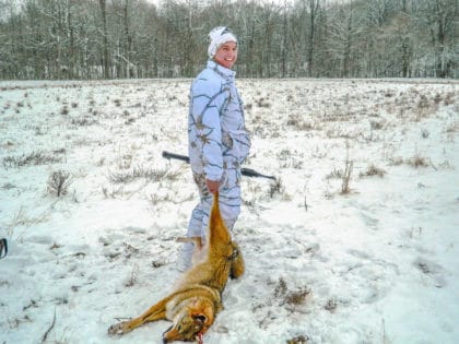 successful coyote hunter using the Basics of coyote calling and set up