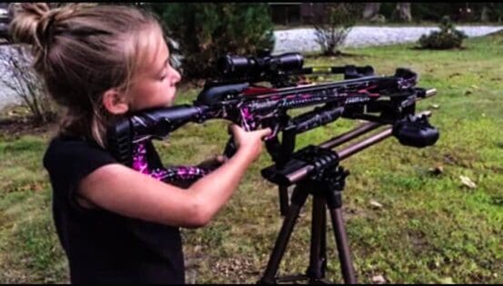 Youth hunter shooting a crossbow