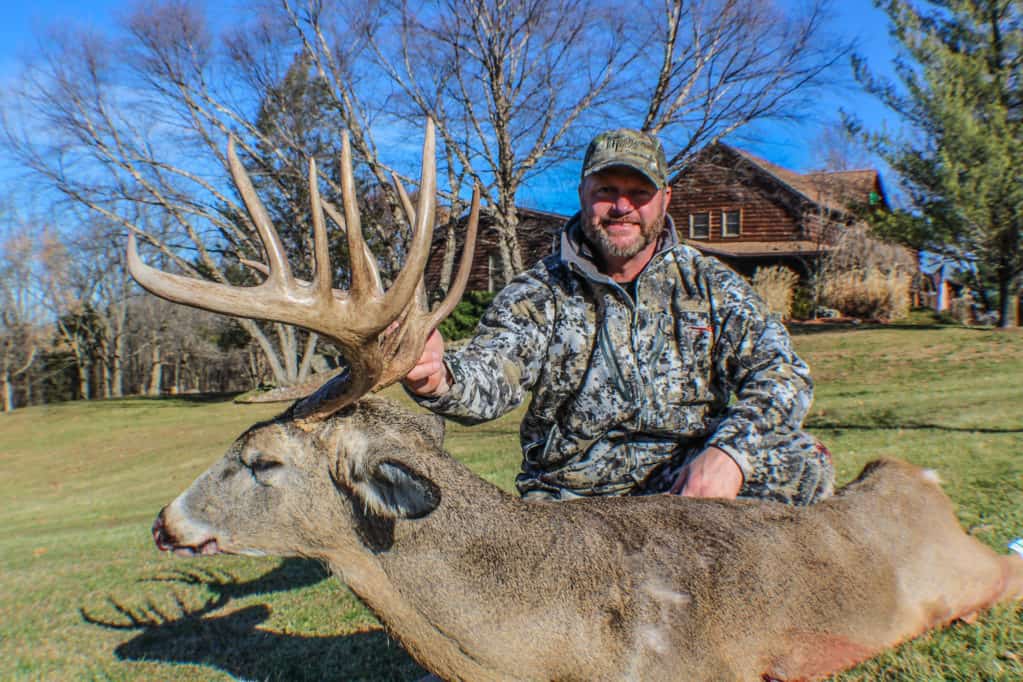 Successful Deer Firearm Hunter in front of Original Lodge
