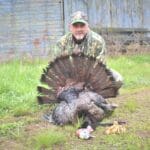 Turkey hunter posing with morel mushrooms