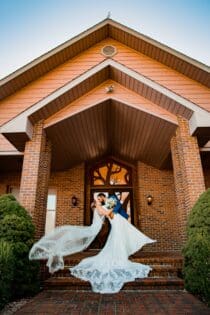 Bride and Groom in front of Sunset Valley Wedding Lodge