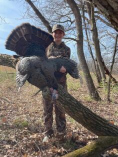 Youth hunter holding up her first gobbler!