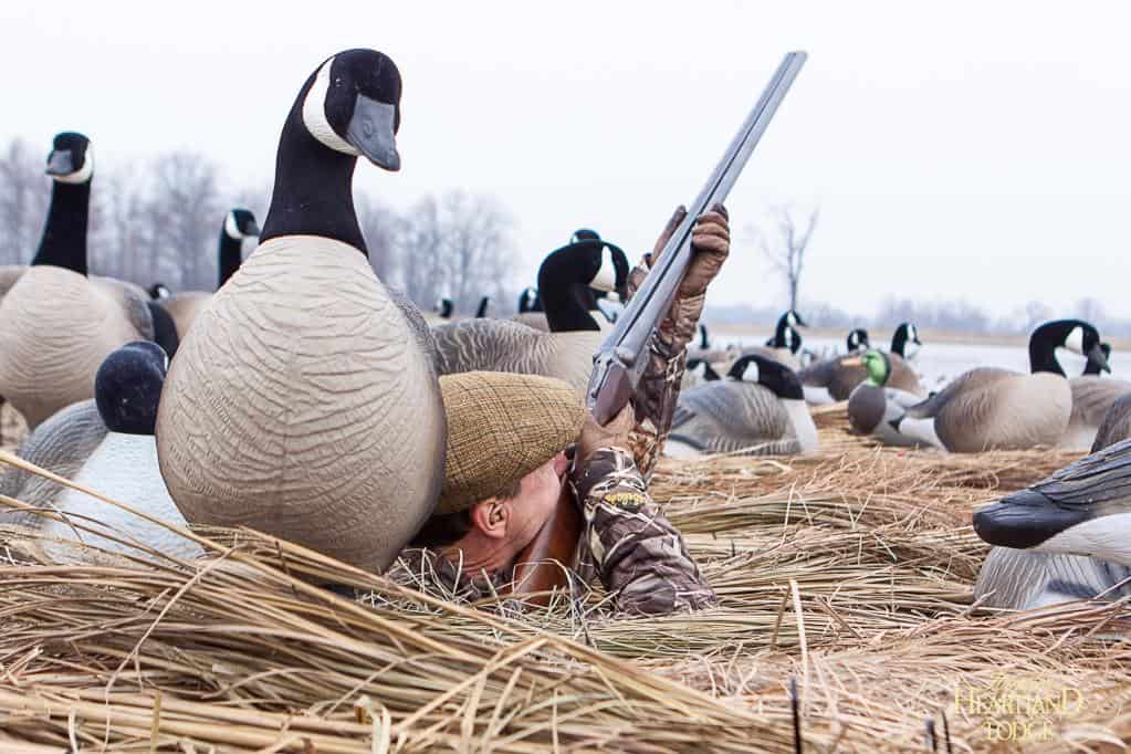 Goose hunter hunting from a pit blind