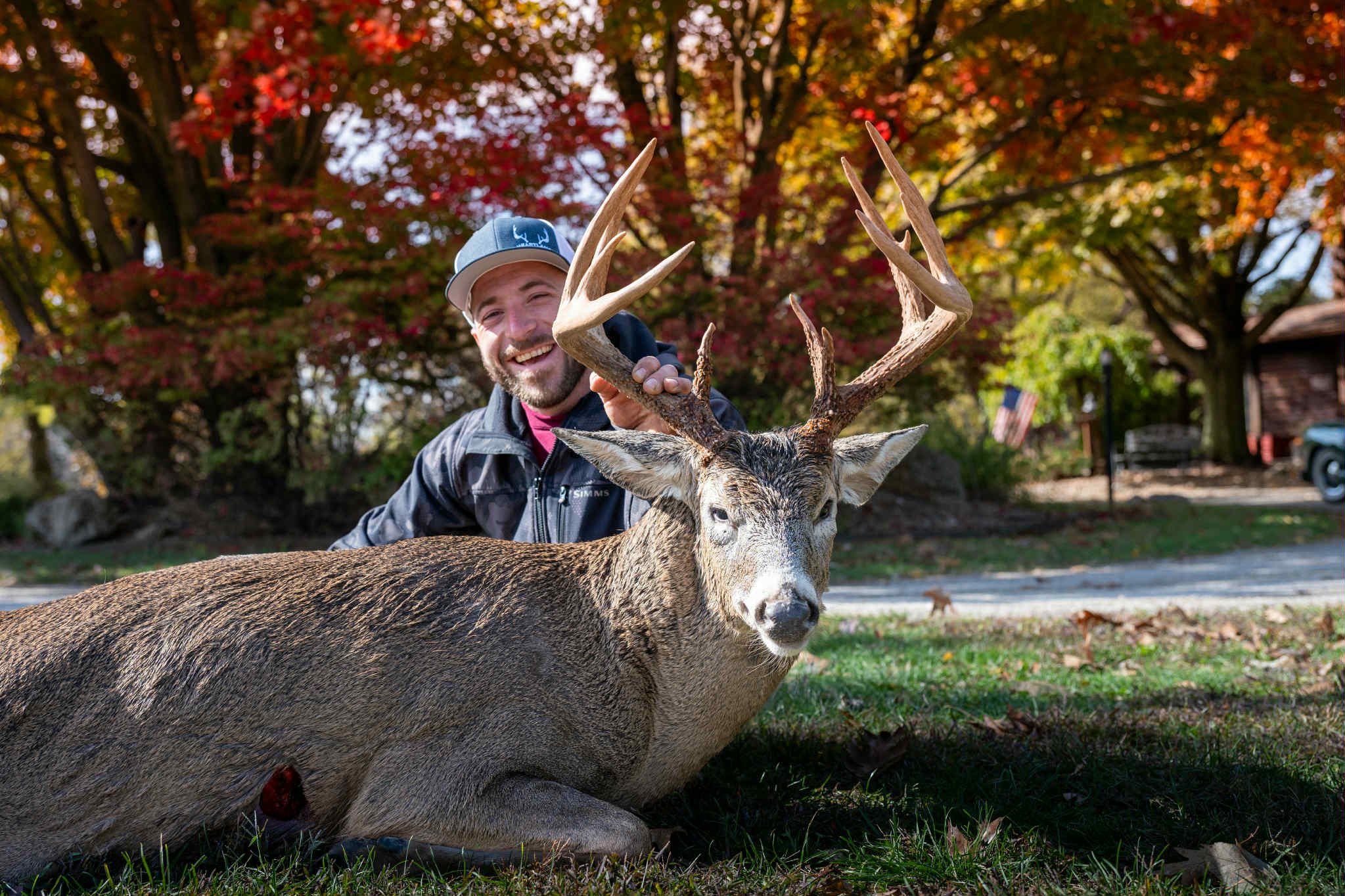 Trophy hunter posing with his big buck