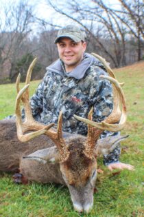 Hunter posing with his big buck harvested in Illinois