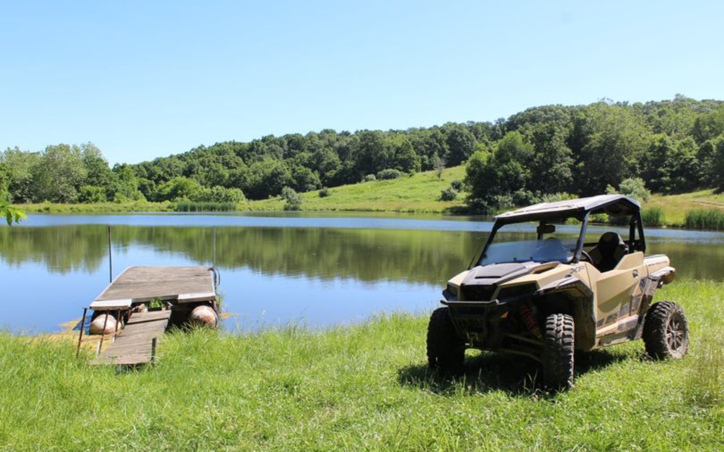 Polaris UTV parked next to one of Heartland's fishing ponds
